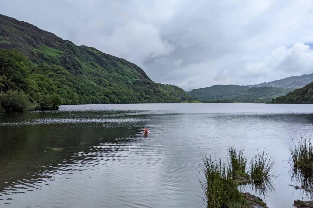 Girl wild swimming in lake