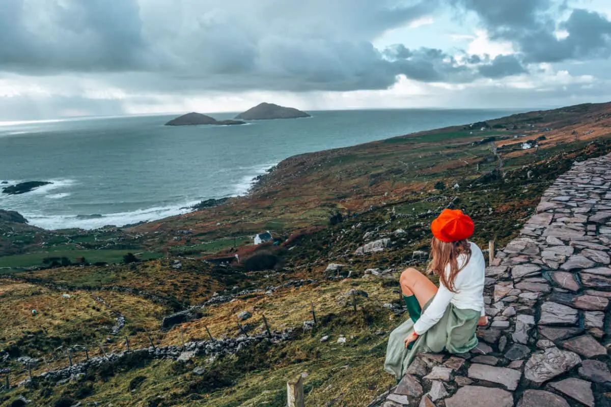 Girl looking out over Irish cliffs