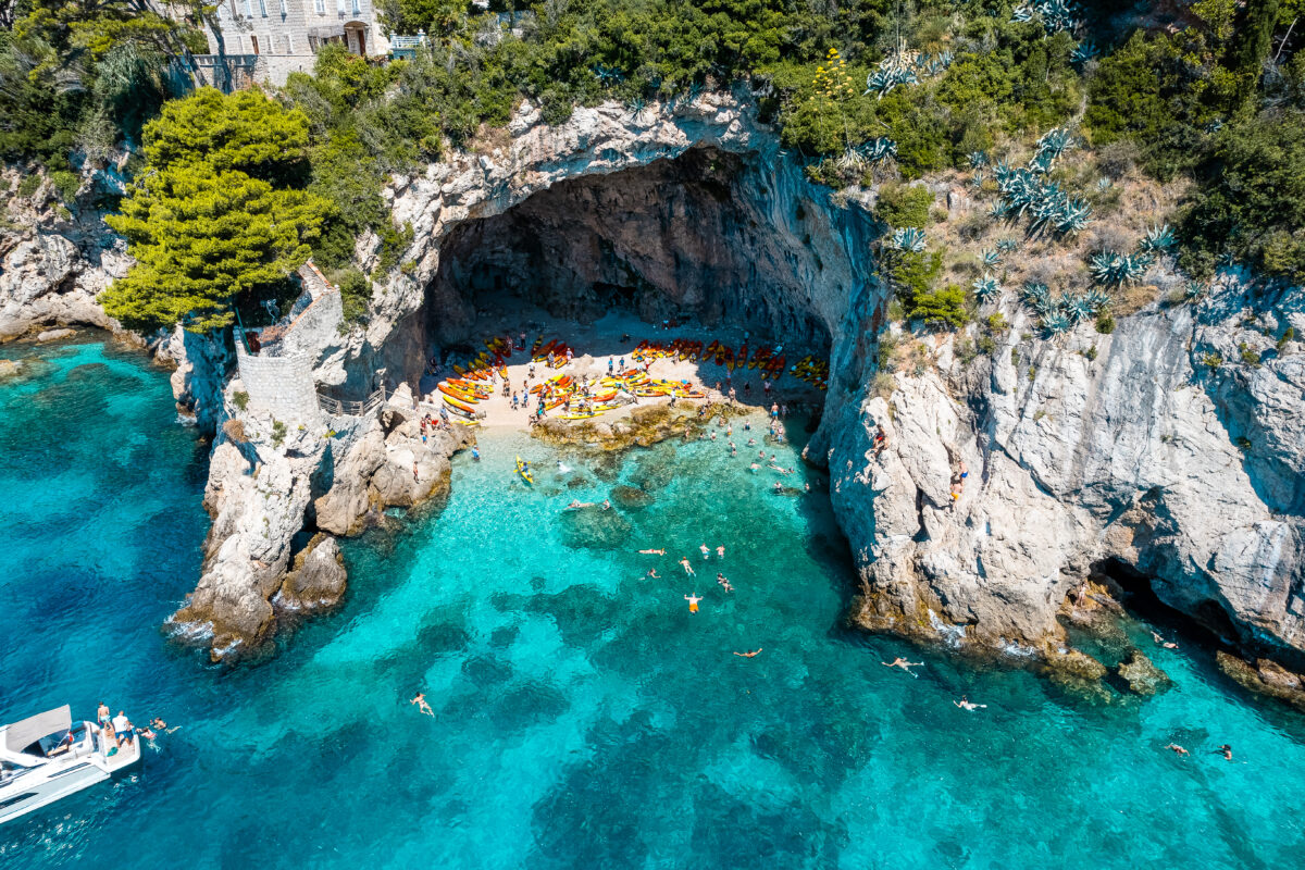 Aerial view of a cove with people swimming